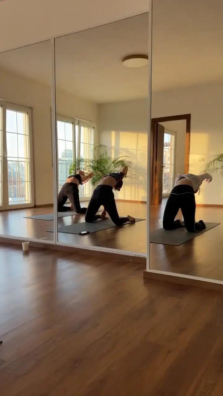Small yoga group practising in the mirrored movement room at Sundara Studio